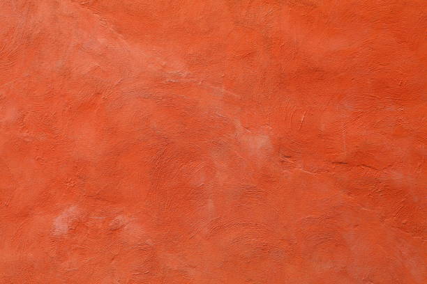 istock artistic painted with fading orange red color on rough surface concrete wall for graphic design background 1165539379