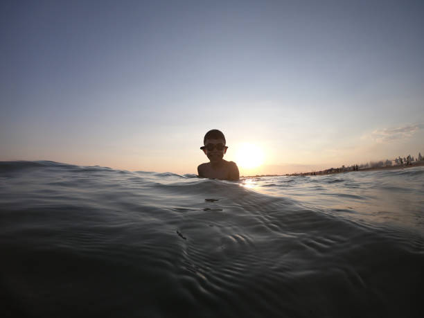 istock Boy floating in the sea 1165540042