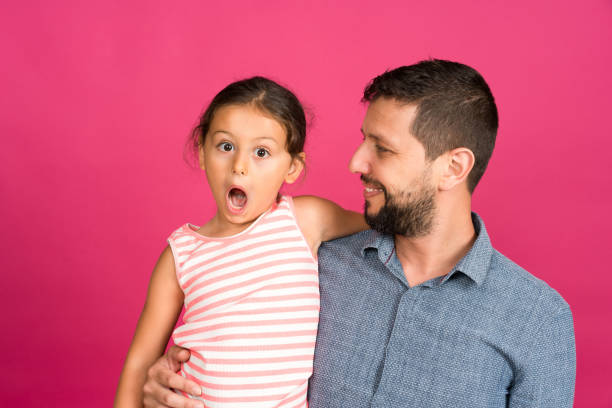 istock Father and daughter making a face 1165541258