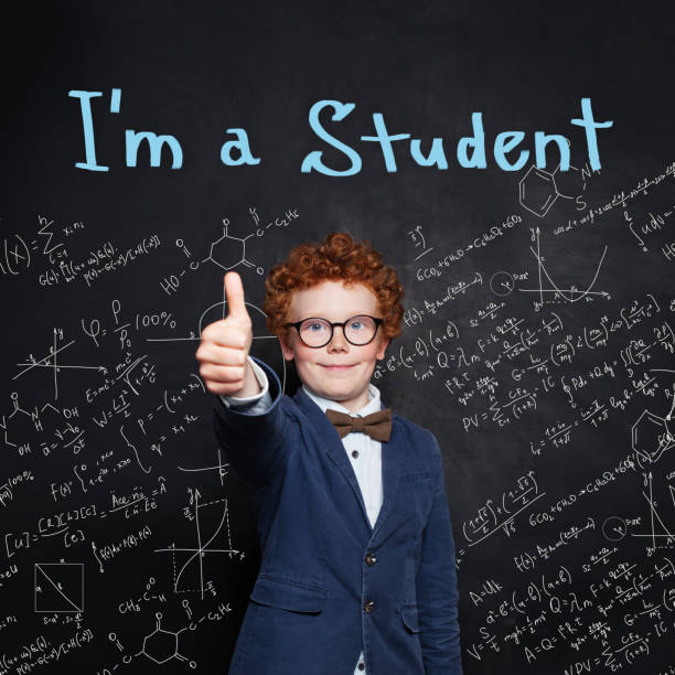 istock Happy student in school uniform showing thumb up and smiling. Back to school 1165543717
