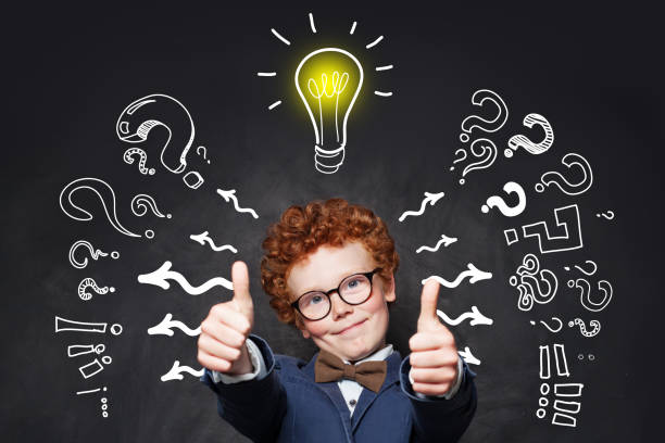 istock Clever boy pupil in glasses with lightbulb on blackboard background 1165543720