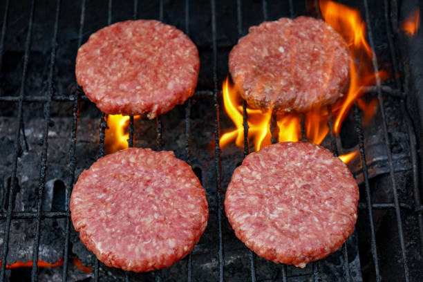 Charcoal BBQ grill with meat.