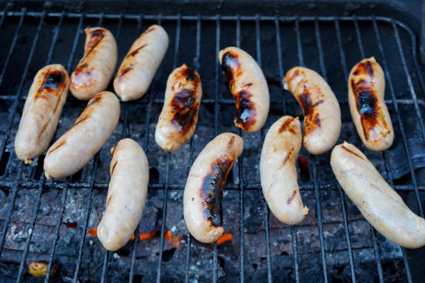 istock Sausages cooking on a BBQ 1165545540