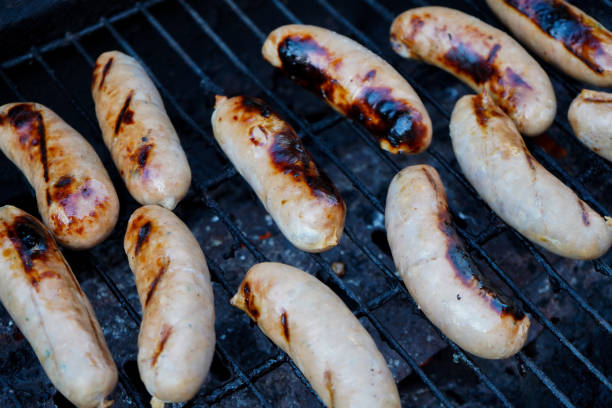 istock Sausages cooking on a BBQ 1165546430