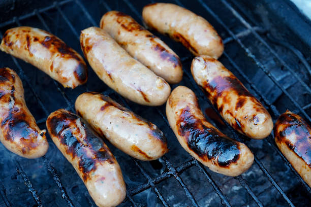 istock Sausages cooking on a BBQ 1165546644