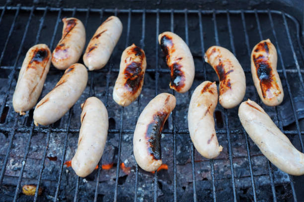 istock Sausages cooking on a BBQ 1165546788