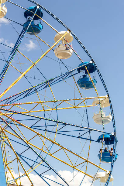 istock Ferris wheel close up against the blue sky and clouds 1165546991