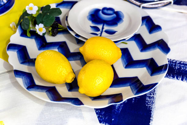 istock Composition with lemons on a blue plate.Fresh yellow lemons 1165548403