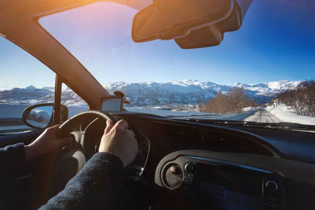 roadtrip - man hands on the wheel and norwegian mountains.  Lofoten Islands. Norway. "n