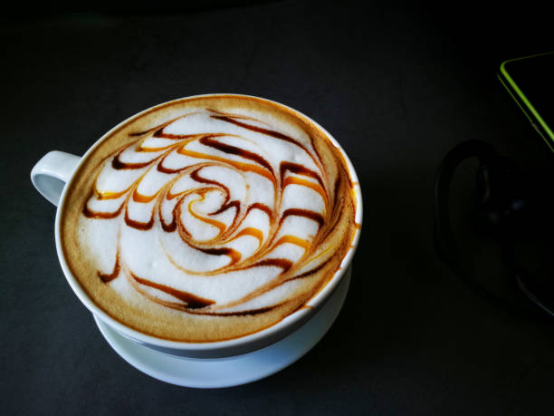 istock Coffee Latte art in white mug and black background 1165554898