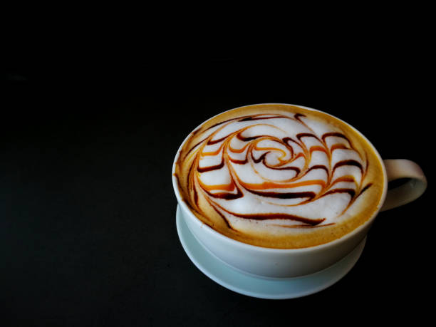 istock Coffee Latte art in white mug and black background 1165554979