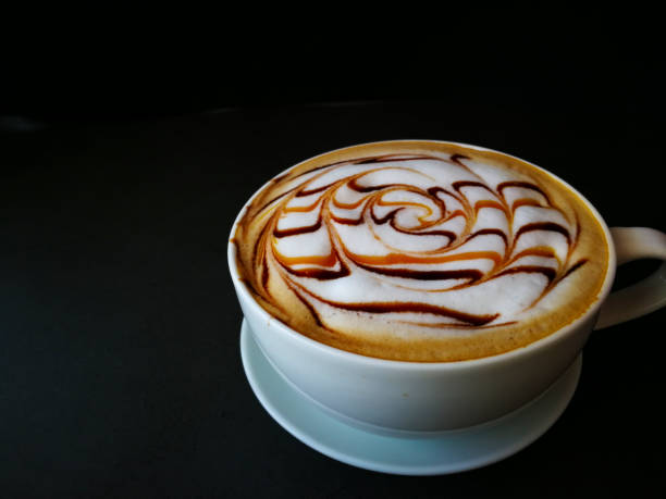 istock Coffee Latte art in white mug and black background 1165554980