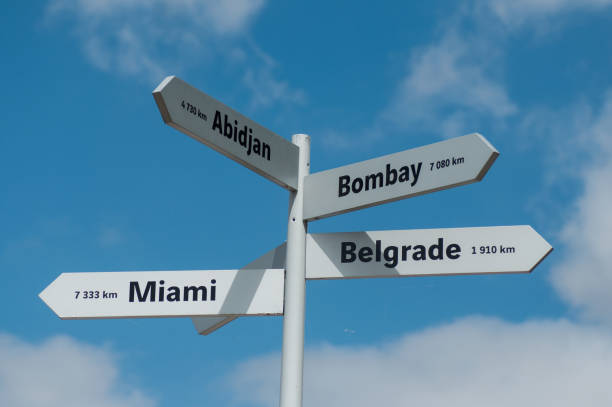 istock destination panels with different cities for holidays on cloudy sky background 1165555144