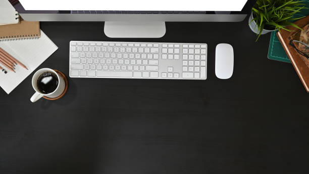 istock Office desk computer and office supplies with coffee on black table. 1165558413