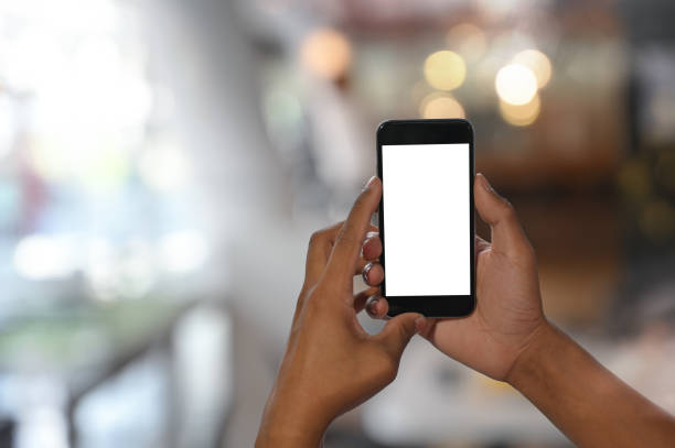 istock Cropped shot man's hands using mockup smartphone in room background with bokeh. 1165558459