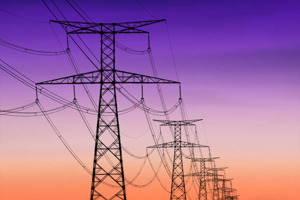 istock high voltage pylons silhouette , sunset lighting, clear sky background 1165559898