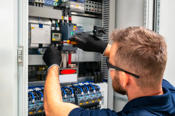 Electrician working at electric panel stock photo