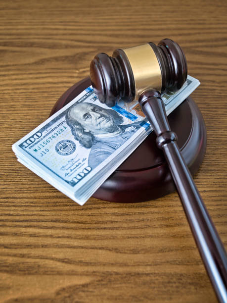 istock Judge gavel and stack of 100 dollar bills 1165562640