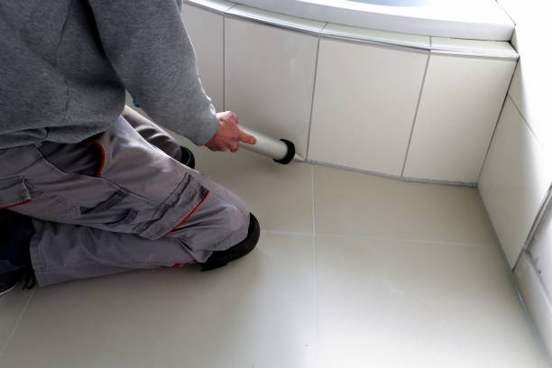 istock Man sealing a bath or basin with silicone 1165563593