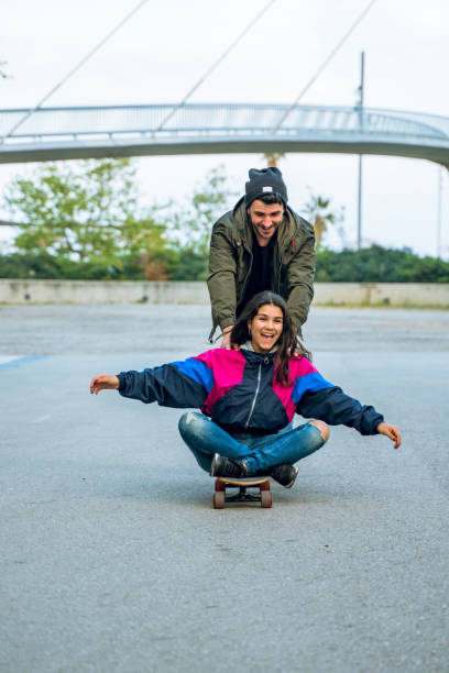 istock Having fun together with a longboard in Barcelona 1165566037