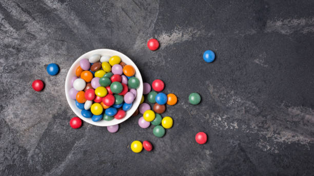 istock Chocolate multicolored glaze dragee or candies in white bowl 1165566333