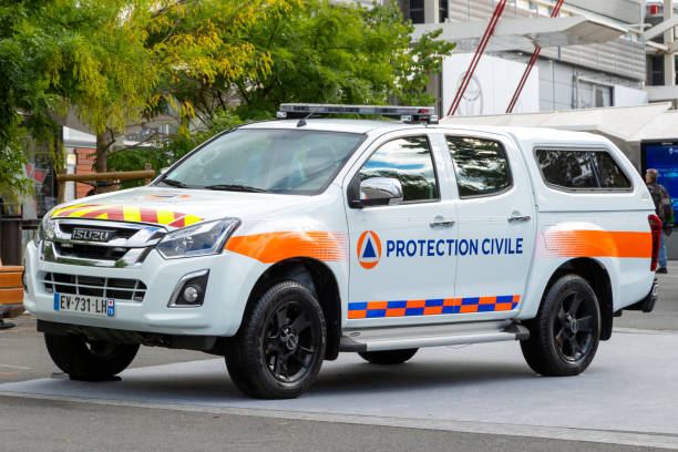 French Securite Civil Isuzu pickup truck Paris - Oct 3, 2018: French Securite Civile (Civil Defence Agency) Isuzu pickup truck standing guard at an event in the city of Paris. french civil protection stock pictures, royalty-free photos & images