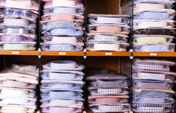 istock Clothing store. Shelves with shirts of different sizes 1165572064