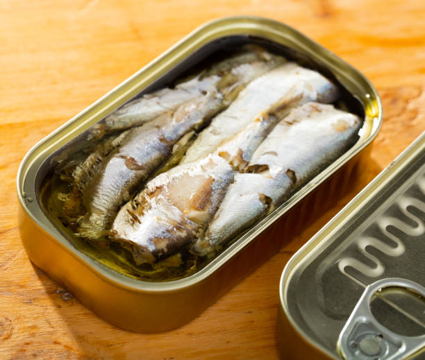 istock Tin can with smoked sprats, sardines, closeup 1165573423