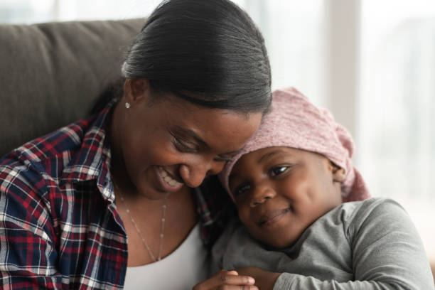 istock Supportive mother holds child with cancer 1165575945