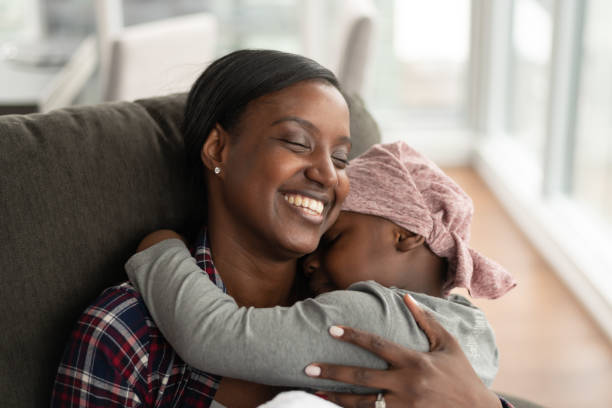 istock Supportive mother holds child with cancer 1165575949
