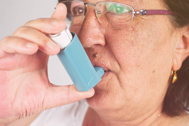 istock Old woman using asthma inhaler. Asthma Treatment, Elderly Person 1165575979