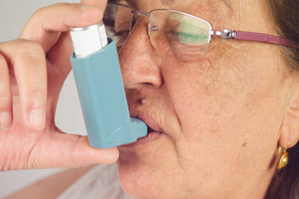 istock Old woman using asthma inhaler. Asthma Treatment, Elderly Person 1165575982