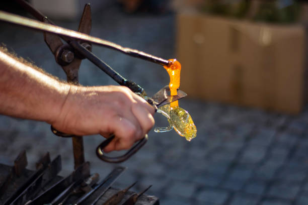 istock making figurines from glass, just pulled out of the oven 1165577527