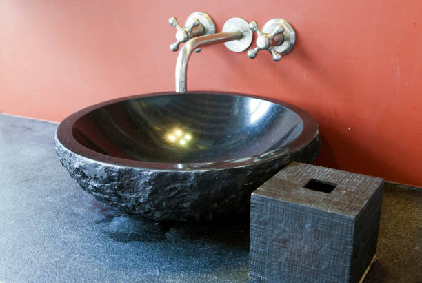 istock black stone sink at the red wall 1165578422