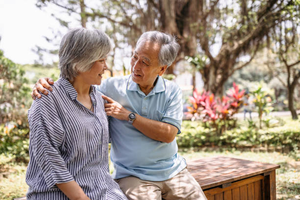 istock Senior couple enjoy on bench at park 1165578725