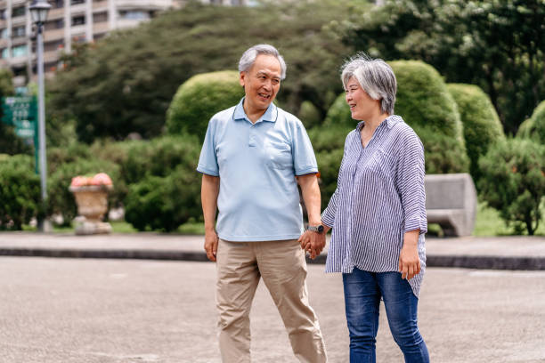 istock Senior couple walking in the park 1165579159