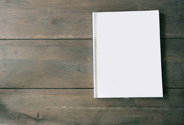 istock Blank magazine or brochure on wooden background texture, top view and space for text emplate for your design. 1165579948