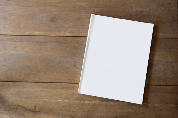 istock Blank magazine or brochure on wooden background texture, top view and space for text emplate for your design. 1165579973