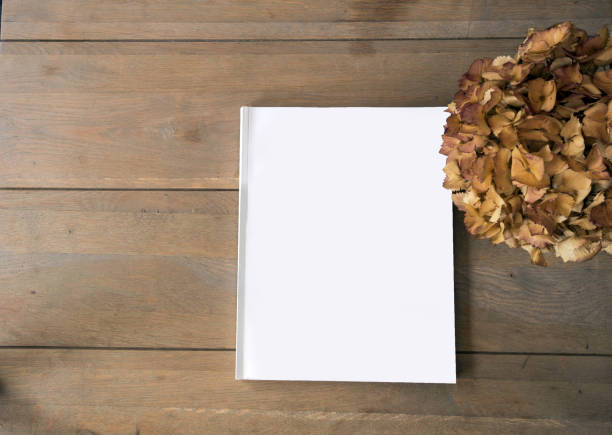 istock Blank magazine or brochure on wooden background texture, top view and space for text emplate for your design. 1165580601