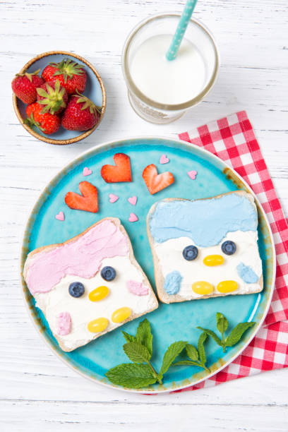 istock Penguin toasts with colored spread on a plate, food for kids idea 1165582208