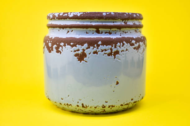 Rusty tin view, Blue ceramic jar. Clean for your message, advertising or company logo. Yellow background
