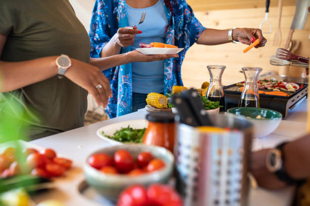 istock Friends preparing vegans food in the kitchen 1165583415