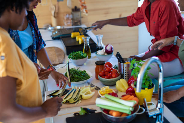 istock Friends preparing vegans food in the kitchen 1165583442