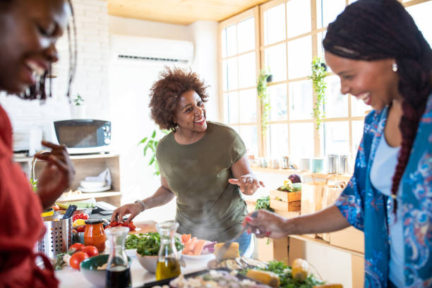 istock Cheerful women making vegan dinner 1165583474