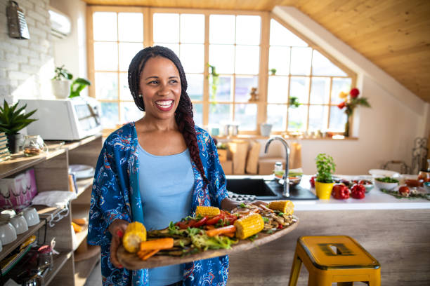 istock She enjoy cooking for her friends 1165583650