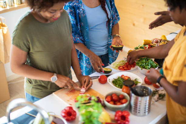 istock Group of young women cooking in the kitchen 1165583664