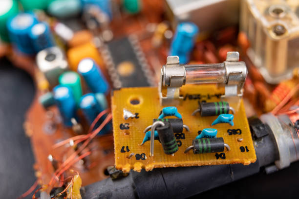 istock Electronics from old electronic devices. Parts for repair in an electronics workshop. Dark background. 1165584553