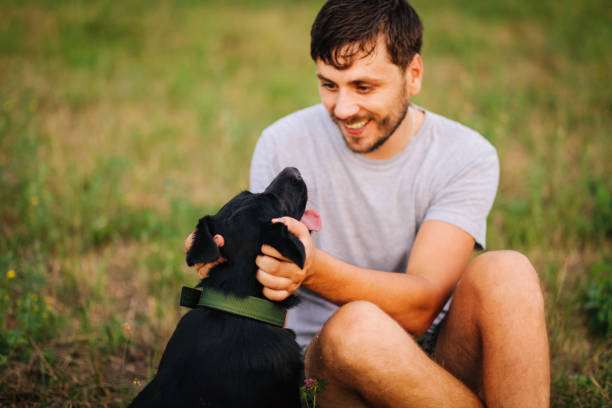 istock Guy and his dog having a fun in the nature 1165587420