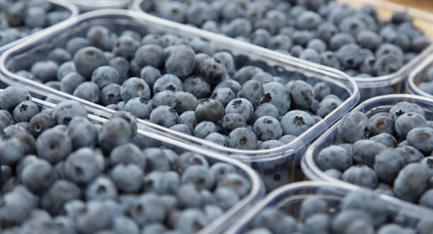 istock Fresh blueberries, farmer market counter. 1165588194