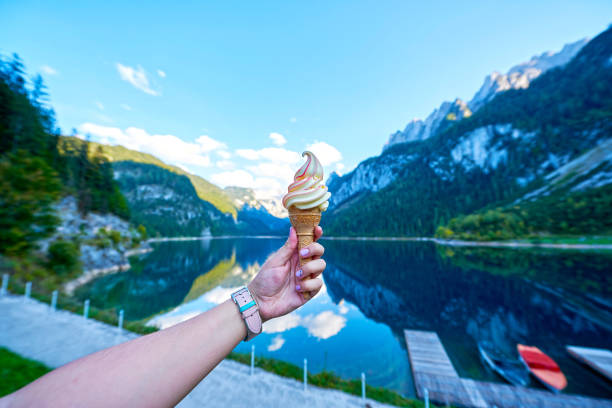 istock Beautiful Gosausee lake landscape with hand and ice cream, Dachstein mountains, forest, clouds and reflections in the water in Austrian Alps. Salzkammergut region 1165588574